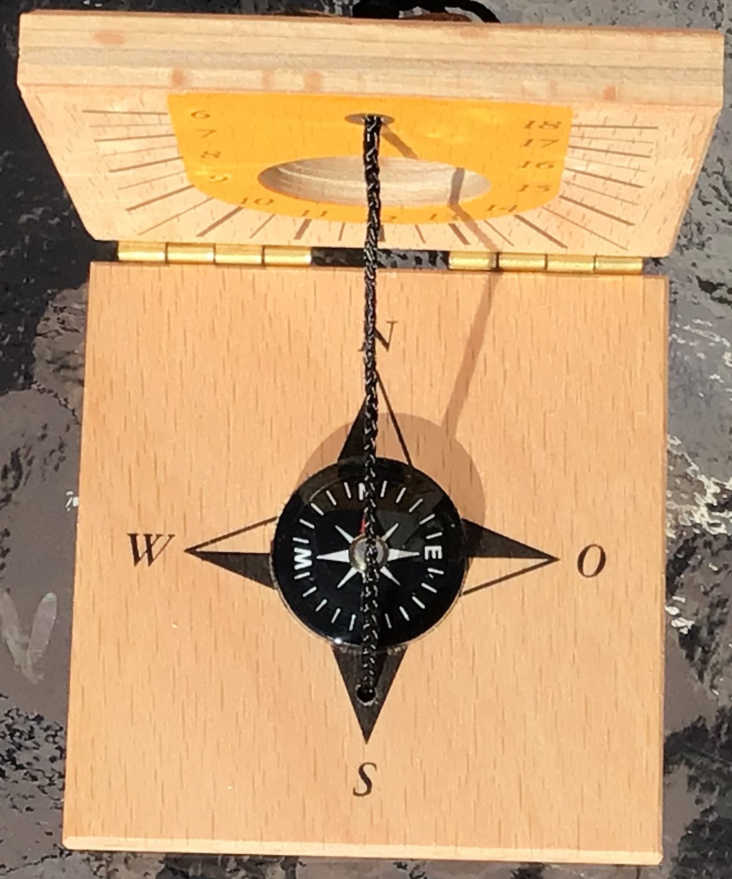 Modern sun dial with string and compass